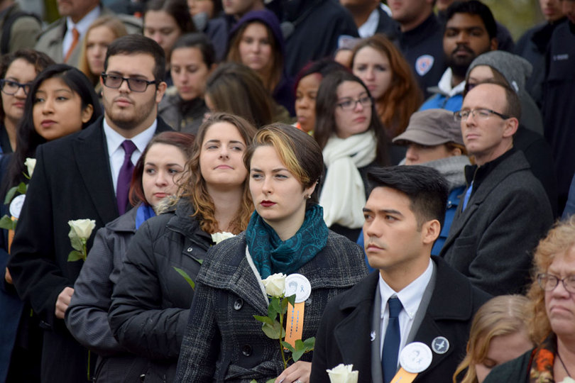 (Center) Farrell Brenner — one of the 2016-17 Remembrance Scholars — waits to place her rose. 
