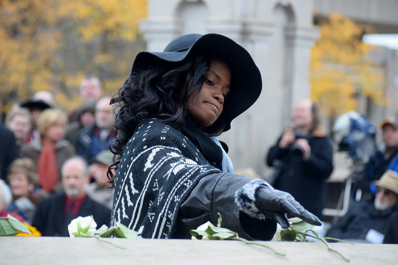 Remembrance Scholar Miracle Rogers lays a rose for Kesha Weedon.
