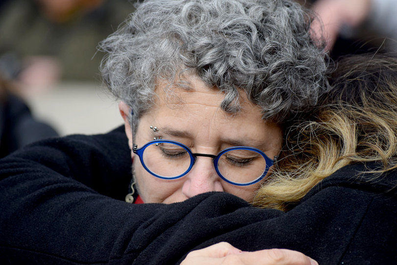 Harriet Brown, an associate professor in the S.I. Newhouse School of Public Communications, hugs her daughter, Soleil Young, following the Rose Laying Ceremony.
