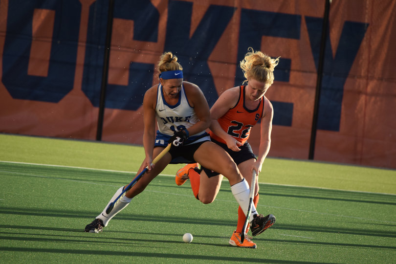 Syracuse's Elaine Carey and Duke's Robin Blazing jostle for position. 