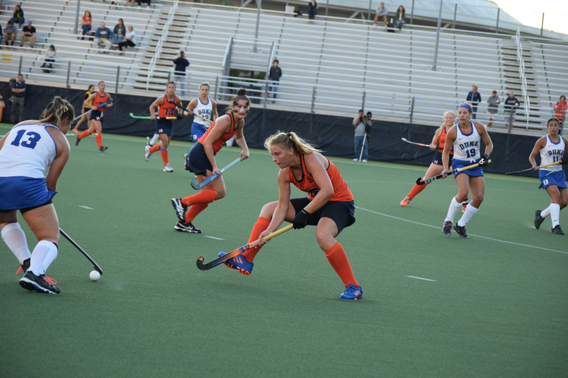 Duke's Rose Tynan dries to carry the ball past the Syracuse defense. 