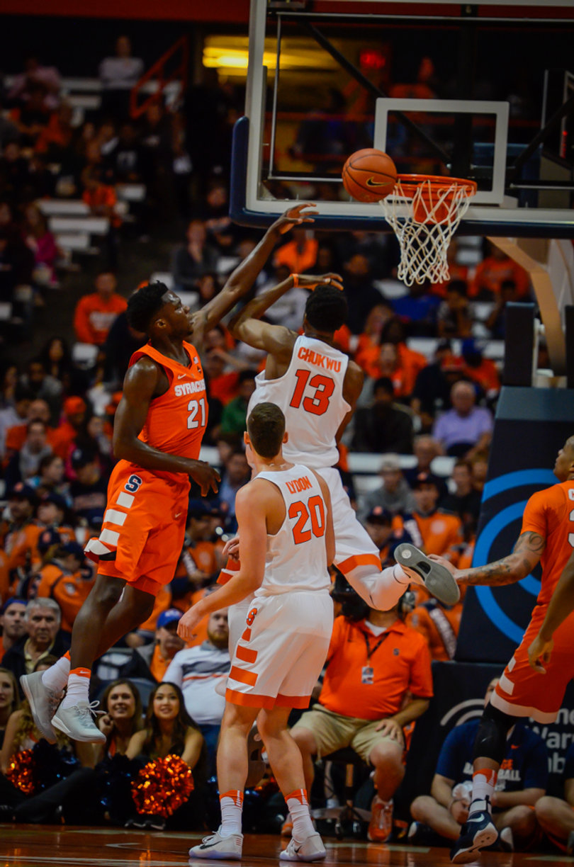 Tyler Roberson (left) goes up to block an Andrew White layup attempt.