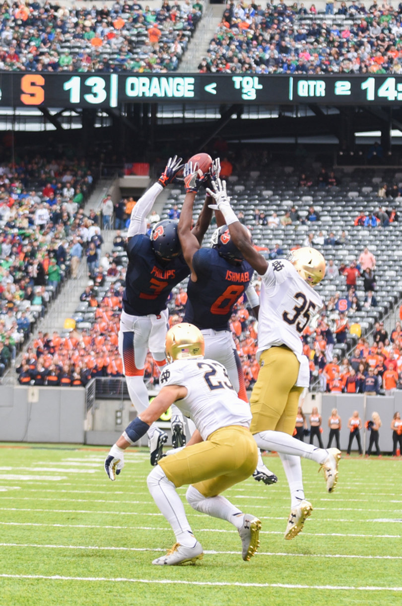 Orange receivers Ervin Philips and Steve Ishmael jump up to catch a pass. The ball tipped off Philips and ultimately Ishmael came down with the ball, despite the two getting in each other's way.