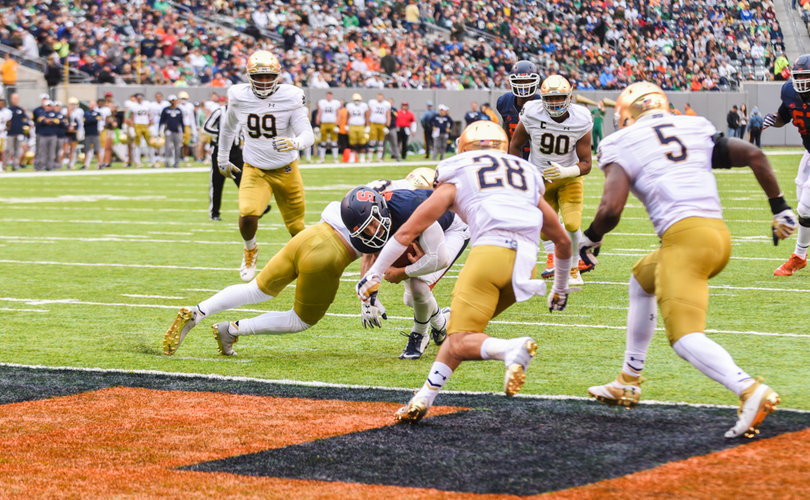 Eric Dungey dives toward the end zone, trying for one of his three rushing touchdowns.