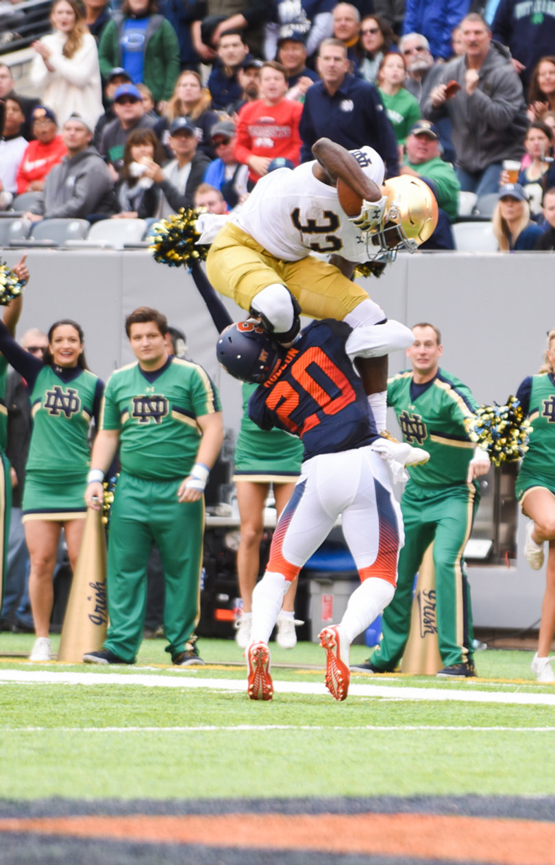 Notre Dame running back Josh Adams tries to hurdle Syracuse cornerback Cordell Hudson along the sideline. Hudson was infamously hurdled by Louisville QB Lamar Jackson in Week 2.