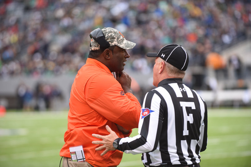 Dino Babers speaks with a referee. His team was called for five penalties.
