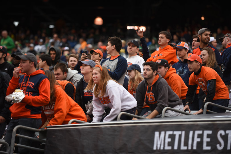 Syracuse fans pound on the seats in front of them. Dozens of students made the trip by bus to East Rutherford, New Jersey.