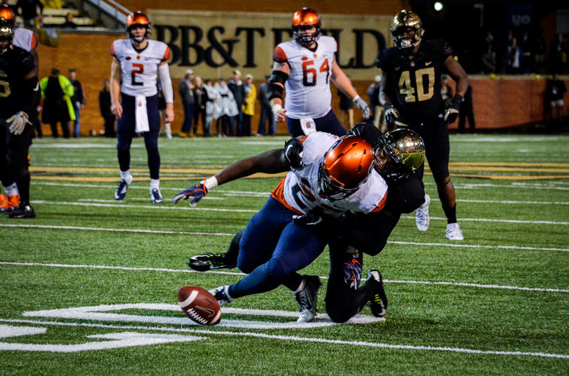 SU running back Jordan Fredericks gets tackled to the ground.