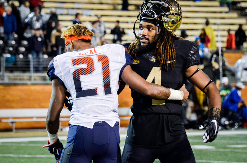 Moe Neal hugs Wake Forest's Rocky Reid. The two went to high school in nearby areas.
