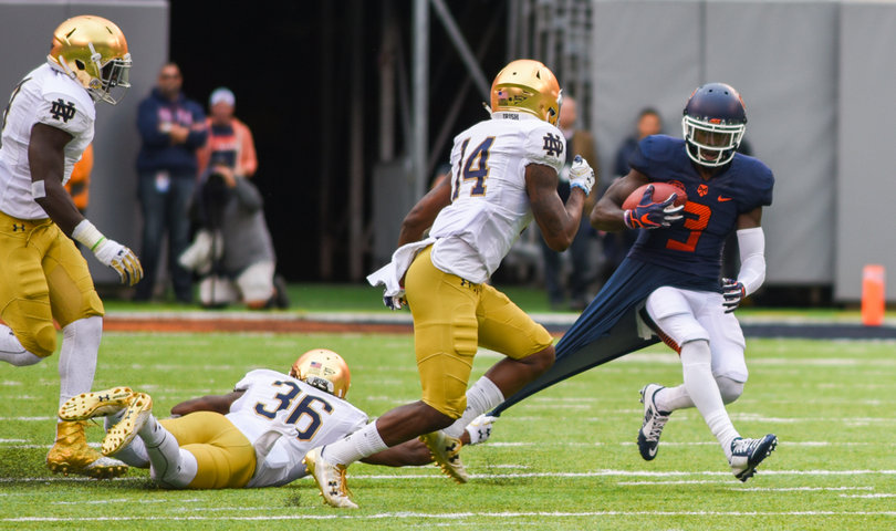 Syracuse receiver Ervin Philips gets part of his undershirt torn by UND cornerback Cole Luke, who was trying to tackle him.