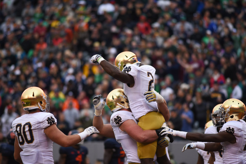 A teammate lifts Dexter Williams into the air after his cutback run score. Williams had 80 yards rushing on eight carries.