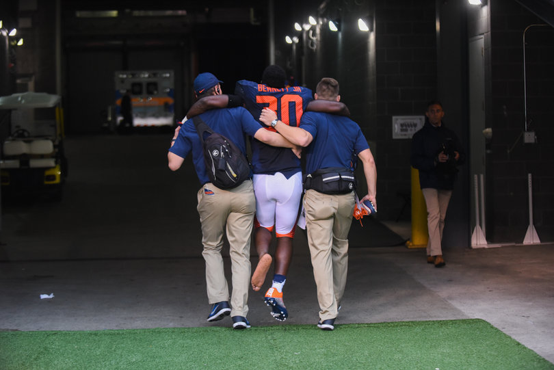 Parris Bennett is helped through the tunnel and back into the team locker room.