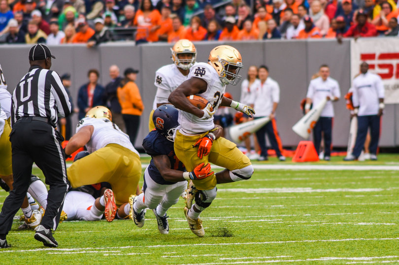Josh Adams gets dragged down by a Syracuse defender. He rushed for 102 yards on 20 carries.