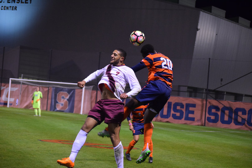 Orange defender Kamal Miller heads the ball away from Virginia Tech forward Som Essome. Miller helped SU to a shutout.