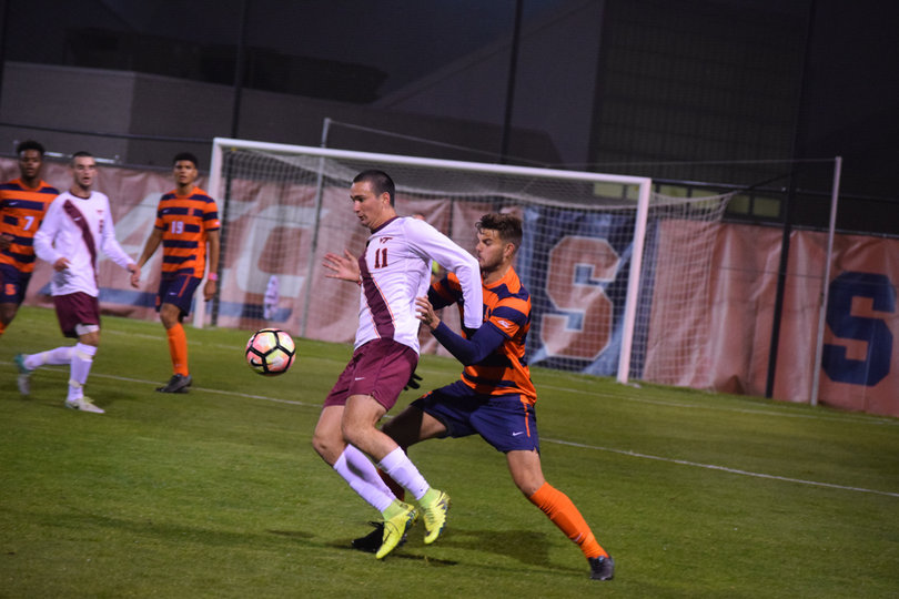 Orange defender Louis Cross bodies up Virginia Tech's Marcelo Acuna. The VT forward came into the game with nine goals — five of which were game winners.