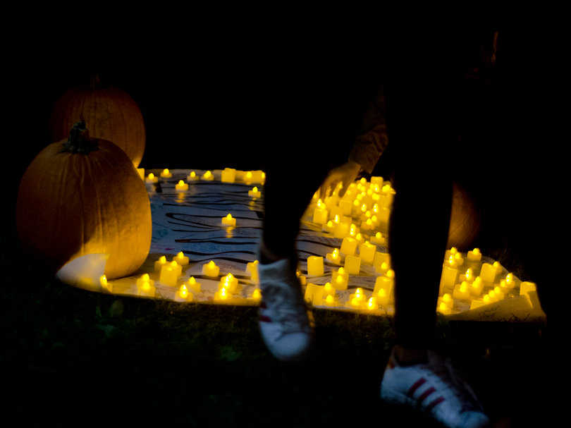 The "All In For Vin" poster and candles were displayed on the lawn in front of Phi Kappa Psi's house on Comstock Avenue.