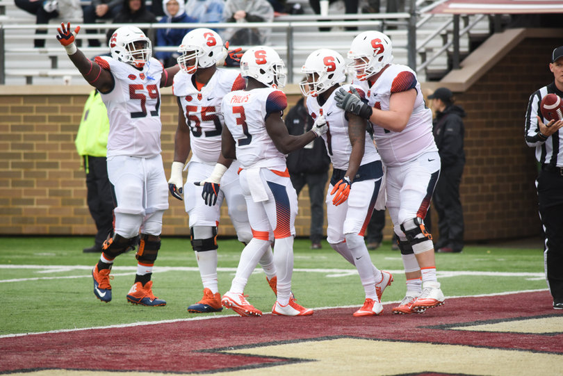 Syracuse players stand in the end zone crowding together.