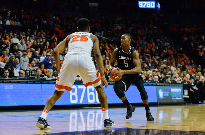 Battle defends TeMarcus Blanton as he drives toward the basket. Blanton scored one basket in his four minutes of play.