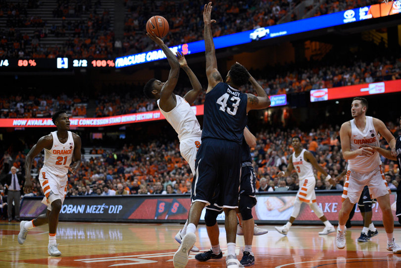 Battle gets off a floater while taking contact from two Hawks defenders. 