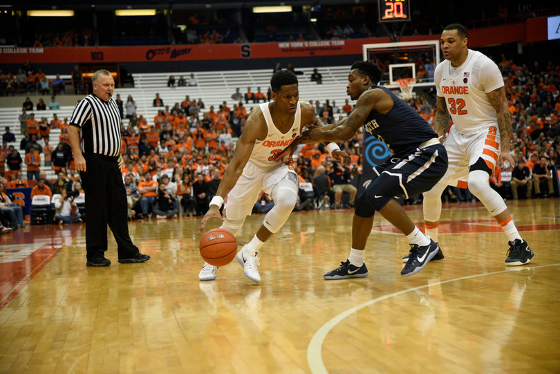 Andrew White drives past a Monmouth defender as center Dajuan Coleman sets a pick on the other side. White scored 18 points but none came in the second half.