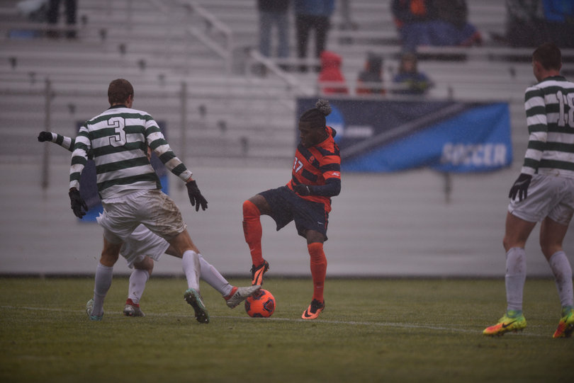 Chris Nanco tries to protect the ball as two Dartmouth defenders close in on him.