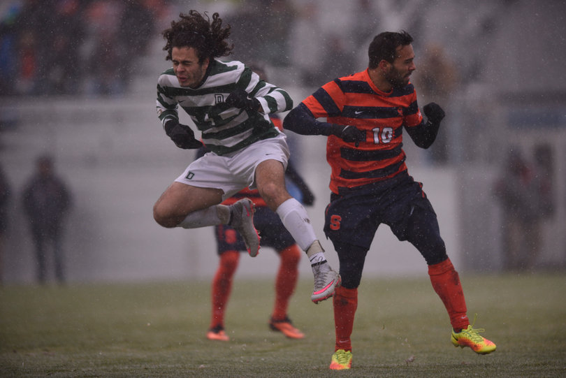 Camargo and a Big Green defender jockey for position.
