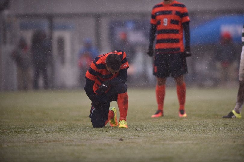 A Syracuse player takes a knee during the contest.