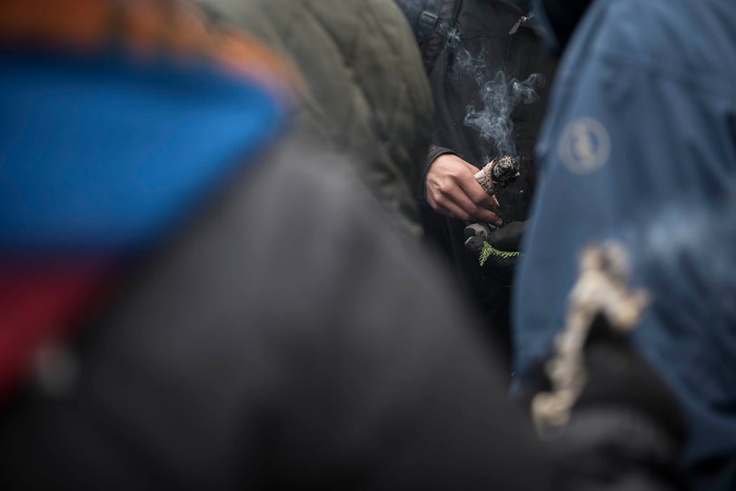 Protectors use Sage to cleanse and bless other protectors before they cross the river closer to police.