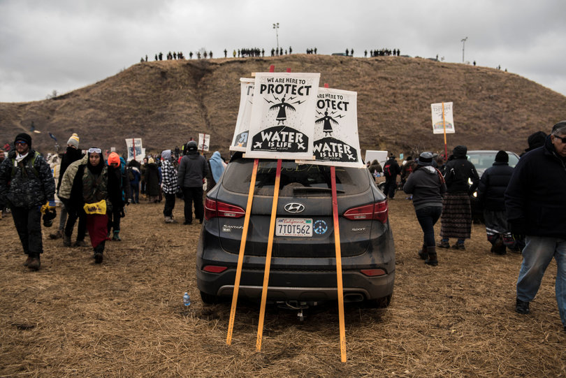 The art tent screen printed signs of solidarity, pictured here, used during direct action to remind both protectors and police that they are peaceful.