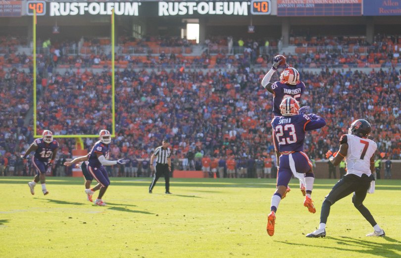 Two Clemson defenders step in front of Etta-Tawo to intercept the pass.