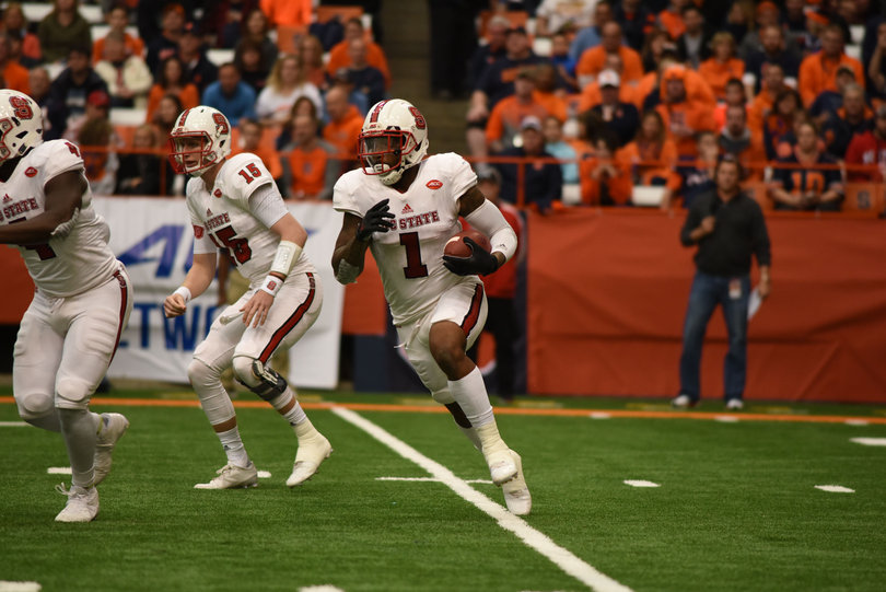 Samuels carries the ball looking for space around the edge.