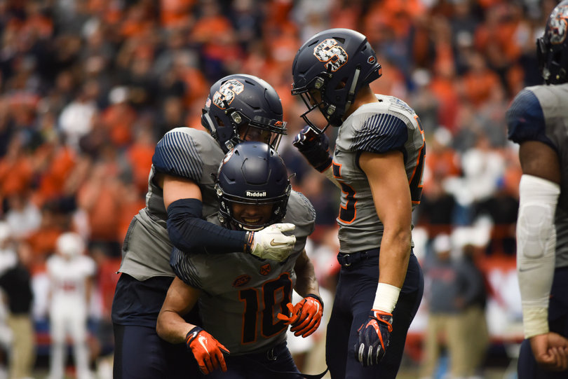 Teammates mob Sean Riley after a key punt block.