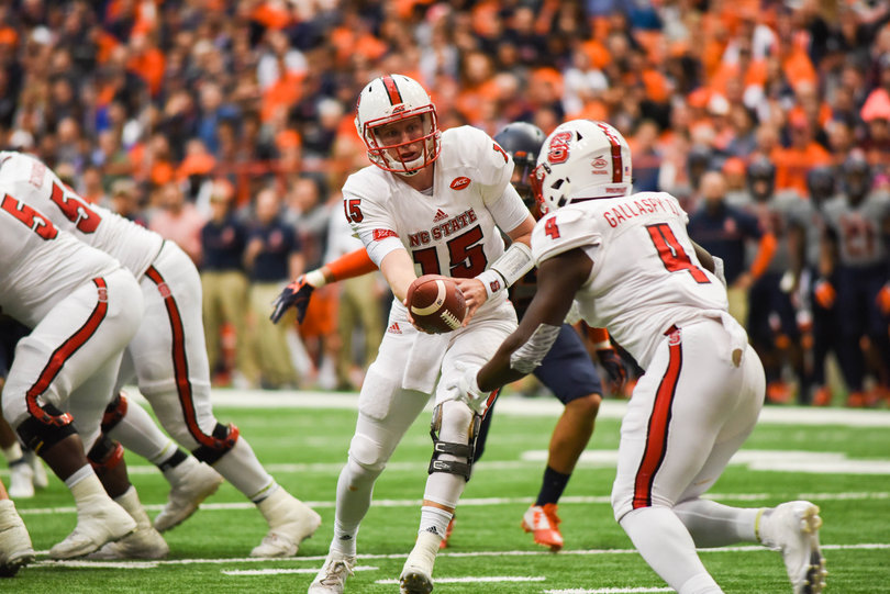 Ryan Finley hands the ball off to Reggie Gallaspy II.