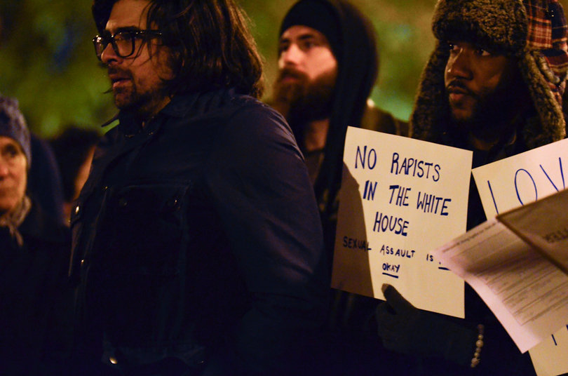 Syracuse residents hold signs in protest of Donald Trump's victory in the 2016 presidential election. 