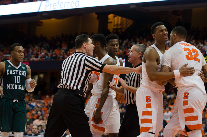 Teammate Andrew White holds back Syracuse center Dajuan Coleman when things got chippy as Syracuse extended its lead.