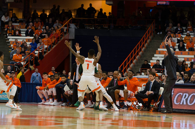 Jim Boeheim demonstrates proper defensive technique to his sophomore point guard Frank Howard.