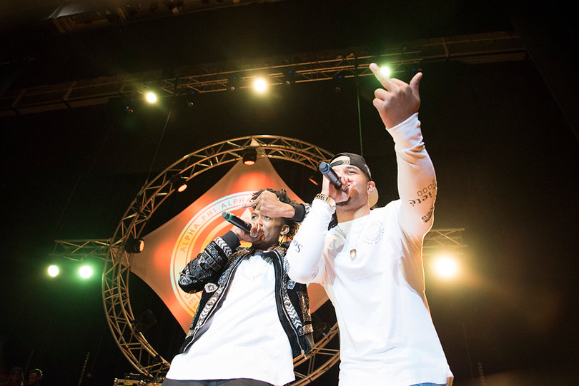 Dru Oliver and Jay Olad perform together on stage.