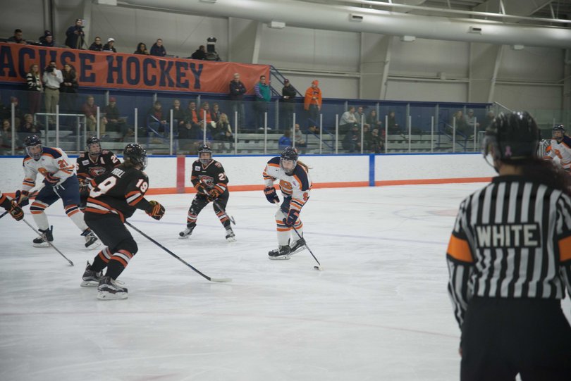 Munroe possesses the puck with her eyes looking at the net. She scored one of SU's two goals.