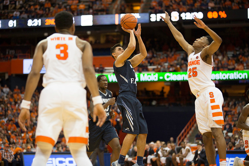 A North Florida player pulls up for a shot in front of Battle.