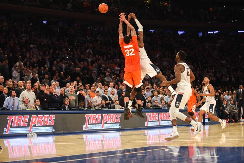 Dajuan Coleman and a Connecticut player jump up for a ball. Coleman had 10 points and 16 rebounds.