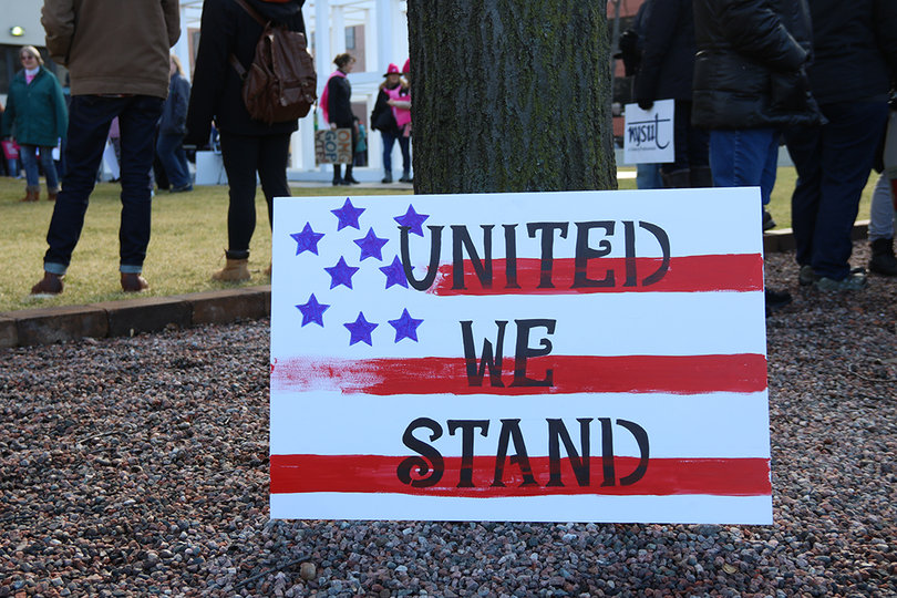 A sign reads "United we stand." Unity was a major theme of "Syracuse in Solidarity" as it brought together people passionate about a range of causes.