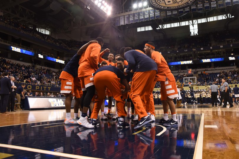 The Orange huddles together before the start of the game. 