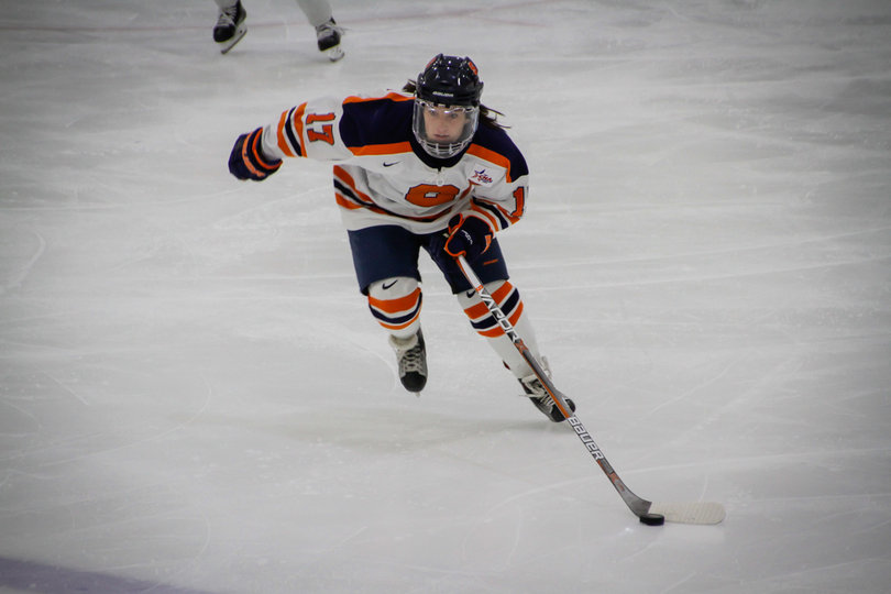 An SU player skates to a loose puck. 