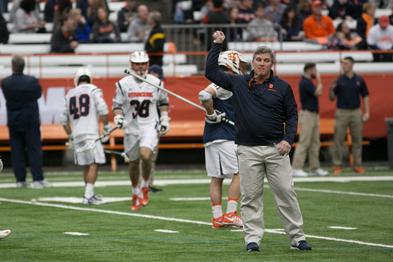 Assistant coach Lelan Rodgers is on the field before the game. 