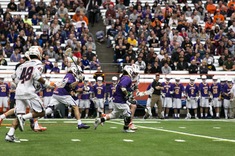 A Syracuse player chases down an Albany player. 