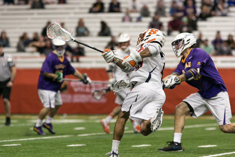 A Syracuse player shoots the ball toward the net. 