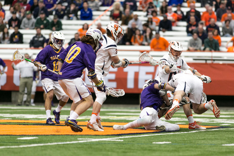 Syracuse and Albany players tussle for the ball. 