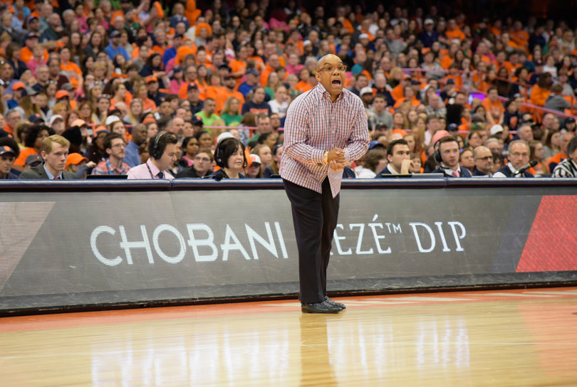 Hillsman, SU's veteran head coach, positions a player on the court. 