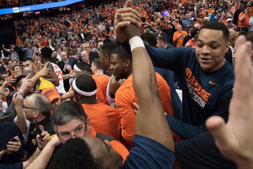 Dajuan Coleman embraces Andrew White on the court as fans flood the hardwood that Gillon lit up. 