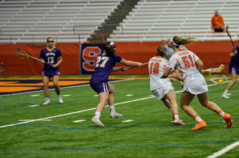 Levy tries her usual sidearm shot, this time around a defender. 